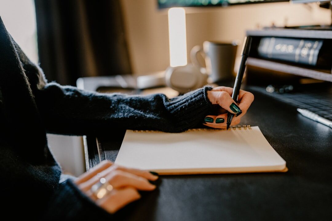 person writing in notebook